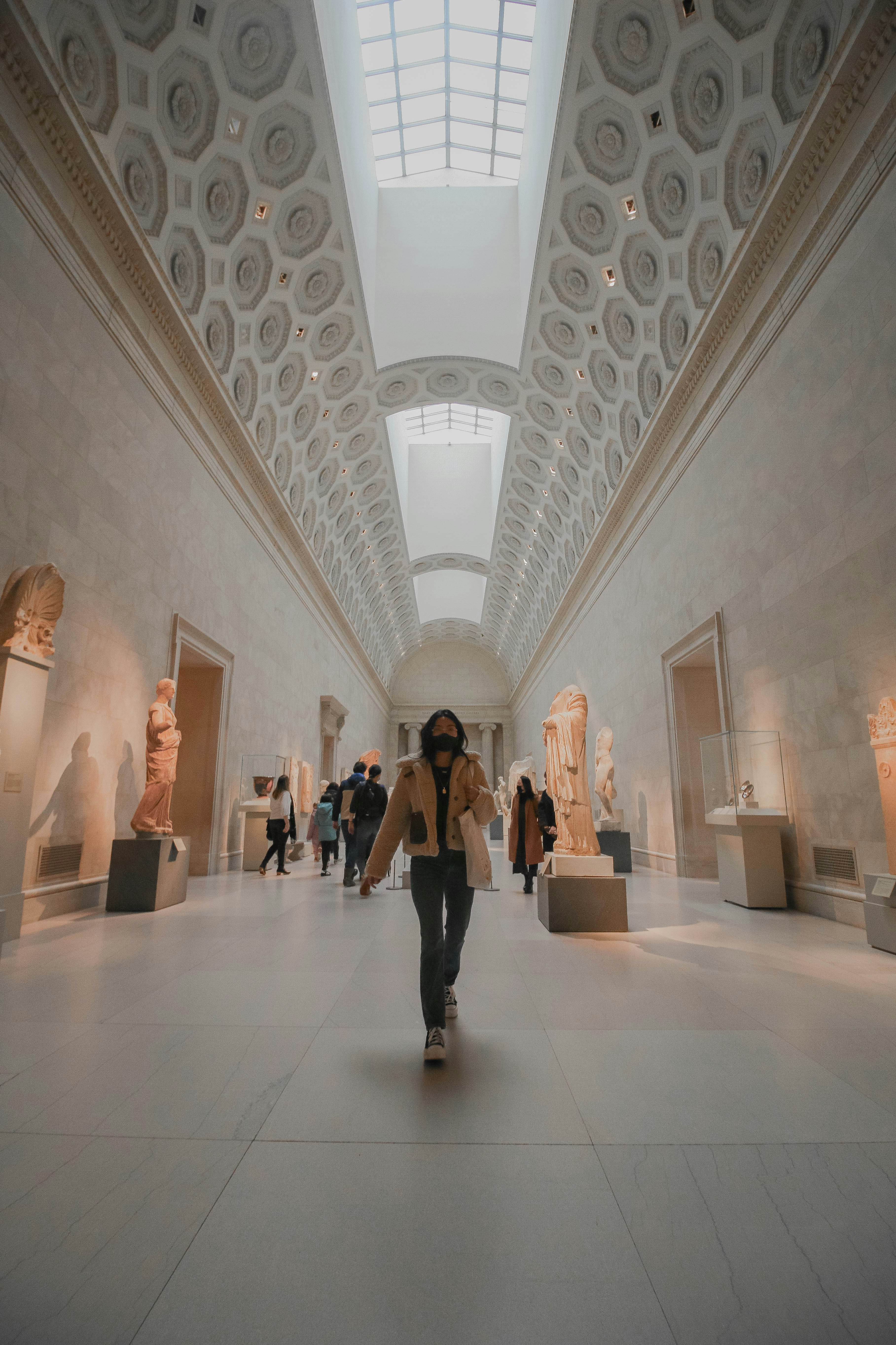 people walking on white hallway